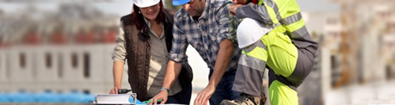 Three people grouped together on a construction site