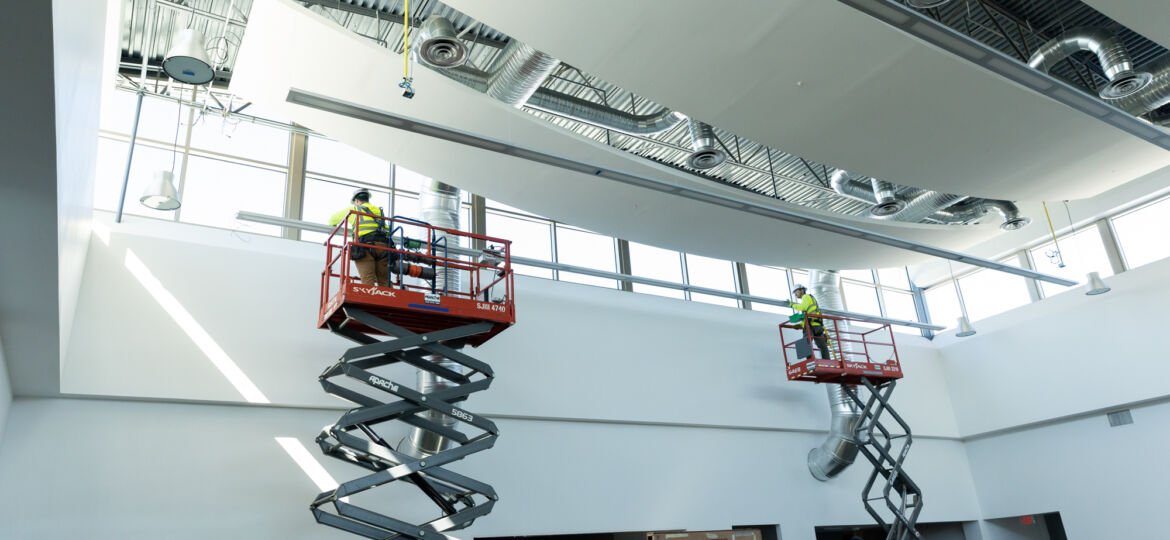 hawkeye employees installing lighting in a commercial building