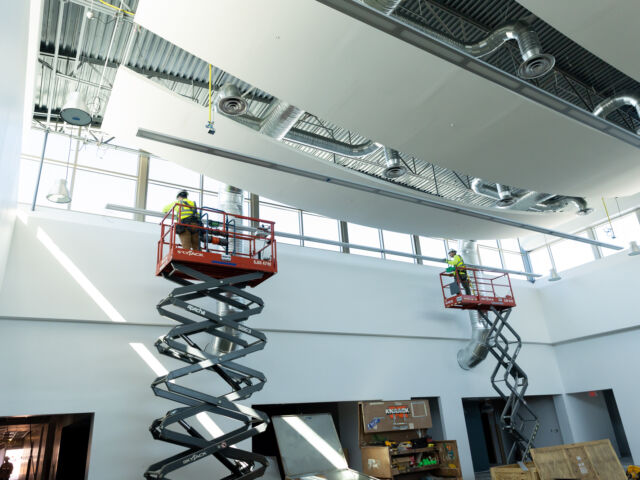 hawkeye employees installing lighting in a commercial building