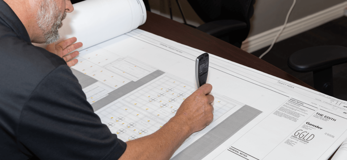 Man working a blueprints of a building