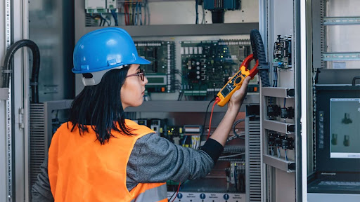 Woman working on an electrical panel