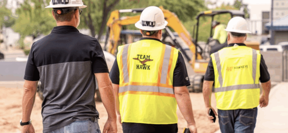 Three employees walking on a job site